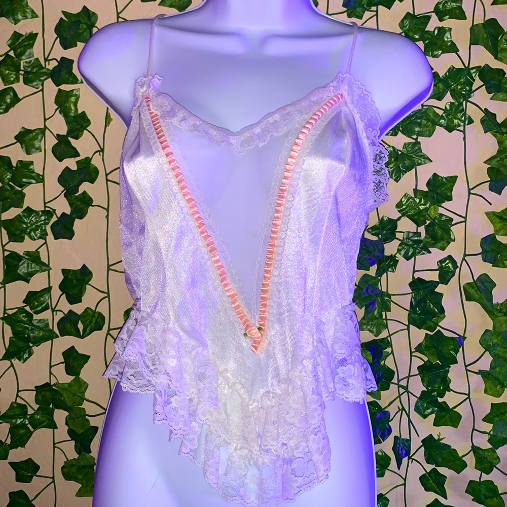 top with detailed pink ruffles and flower